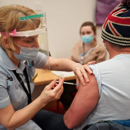 A key worker receives a Covid-19 shot in England. Photo: AFP