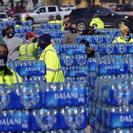 Water to be loaded into vehicles is stacked at a City of Houston water distribution site in Houston on Friday. Photo: AP