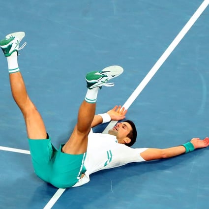 Novak Djokovic celebrates on the ground after winning his ninth Australian Open title by beating Daniil Medvedev in the final. Photo: Reuters
