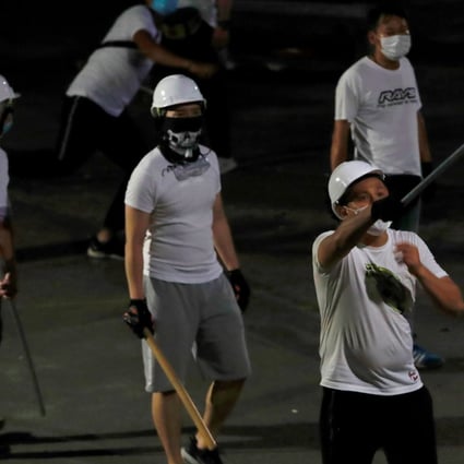 Men armed with wooden sticks and metal poles attacked protesters and MTR passengers on the night of July 21, 2019. Photo: Reuters