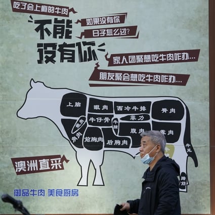 A man in Beijing walks by an advertisment promoting imported beef from Australia. The Australian beef trade with China had a tumultuous 2020 due to the trade suspensions of five processing plants. Photo: AP