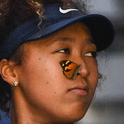 A butterfly lands on Naomi Osaka’s face before she gently carries it to safety during her march to the Australian Open title. Photo: AFP