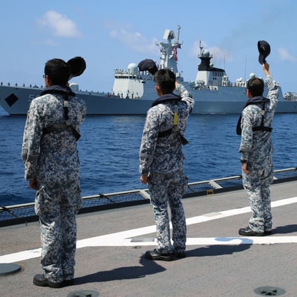 Singapore naval servicemen wave to a departing Chinese frigate after a previous joint exercise. Photo: Xinhua