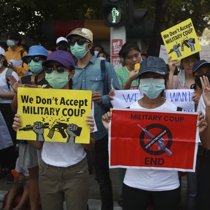 Demonstrators display placards during a protest near the Indonesian embassy in Yangon, Myanmar, on Tuesday. Photo: AP