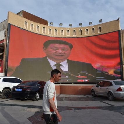 A man walks past a screen showing images of China’s President Xi Jinping in Kashgar in China’s northwest Xinjiang region. More than 1 million ethnic Uygurs and other mostly Muslim minorities are believed to be held in a network of internment camps that Beijing describes as “vocational education centres”. Photo: AFP