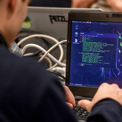 A participant delivers a computer payload while working on a laptop in Lille, France, during the 11th International Cybersecurity Forum in January 2019. Photo: AFP