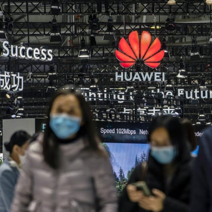 Attendees walk past the Huawei Technologies logo at the MWC Shanghai exhibition in Shanghai on Tuesday, Feb. 23, 2021. Photo: Bloomberg