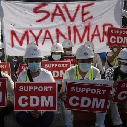 Demonstrators hold placards showing support for the civil disobedience movement (CDM) during a protest against the military coup in Yangon on Thursday. Photo: EPA-EFE