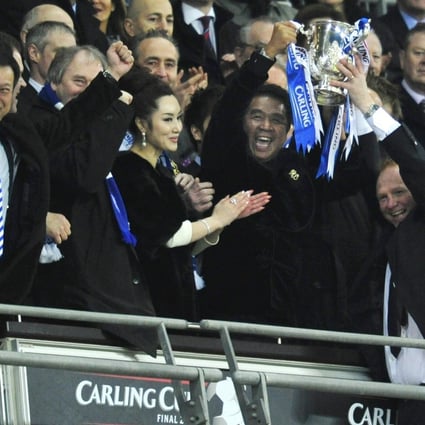 Birmingham City's coach Alex McLeish (right) and Hong Kong owner of the club, Carson Yeung Ka-sing, hold the trophy at the end of the 2011 Carling Cup final. The team beat Arsenal 2-1. Photo: AFP