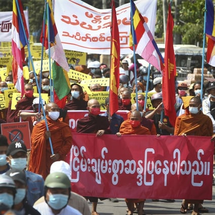 Buddhist monks holding banners and signs lead an anti-coup protest march in Mandalay, Myanmar, on Monday. Photo: AP