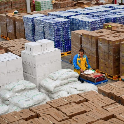 A worker transfers items in preparation for the “Singles‘ Day” shopping festival at a storage facility of Suning in Shenyang in China's northeastern Liaoning province on October 24, 2018. Photo: AFP