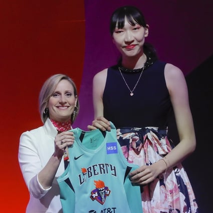 Han Xu of China with WNBA COO Christy Hedgpeth after being selected by the New York Liberty in the second round of the women‘s basketball draft in 2019. Photo: AP
