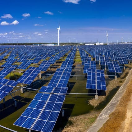 Solar panels and wind turbines cover this area near the city of Yancheng, in the eastern coastal province of Jiangsu. State Grid Corp of China plans to accelerate development of clean energy infrastructure, including wind and solar power for generating electricity. Photo: EPA-EFE