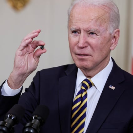 US President Joe Biden holds a semiconductor, as he speaks before signing an executive order, aimed at addressing a global chip shortage, at the White House in Washington, on February 24, 2021. Photo: Reuters