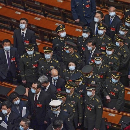 Military delegates leave the opening session of the National People’s Congress in Beijing on Friday. Photo: AP
