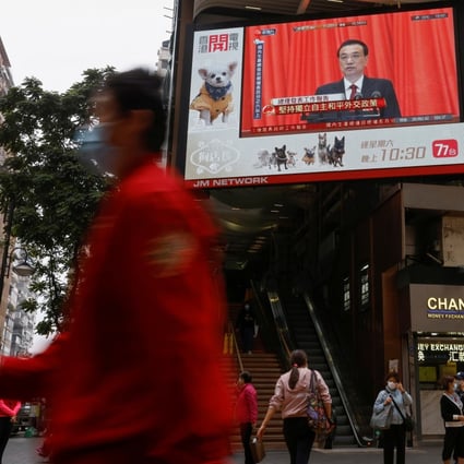 An outdoor screen in Hong Kong shows the opening session of the National People's Congress, where reforms were announced to the city’s electoral process. Photo: Reuters