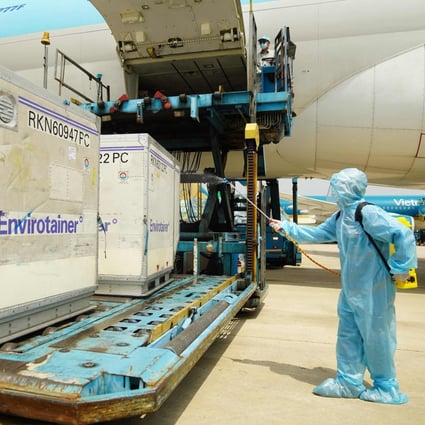 A health official sprays disinfectant on the first shipment of AstraZeneca/Oxford Covid-19 vaccines after its arrival in Ho Chi Minh City on February 24. Photo: AFP