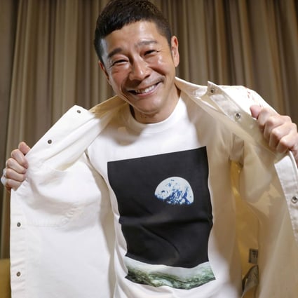 Japanese billionaire Yusaku Maezawa poses with his T-shirt bearing an image of Earth. Photo: Reuters