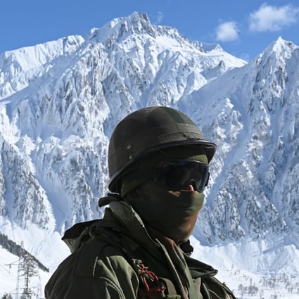An Indian soldier stands guard near a mountain pass that connects Srinagar to Ladakh, bordering China. Photo: AFP