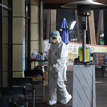 A medical worker sprays disinfectant at a coronavirus testing site in Seoul. Photo: AP