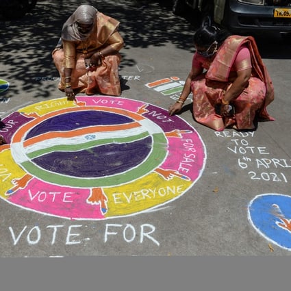 Electoral workers draw traditional folk-art designs urging residents of Chennai, Tamil Nadu, to vote in the coming legislative assembly elections. Photo: AFP