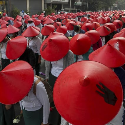 Anti-coup school teachers in their uniform and traditional hats at a protest in Mandalay, Myanmar. Photo: AP