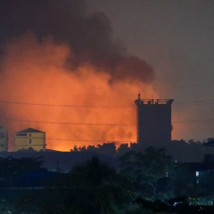 Fire from burning Chinese-owned factories in Myanmar’s industrial township of Hlaingthaya, on the outskirts of Yangon, is seen in the early hours of Monday morning. Photo: EPA