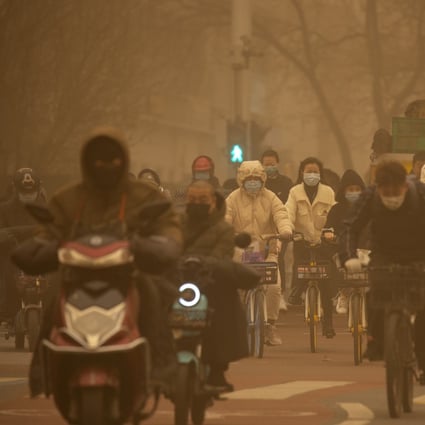 A sandstorm in a Beijing intersection is evidence of the difficulty in curbing the spread of deserts. Photo: AP