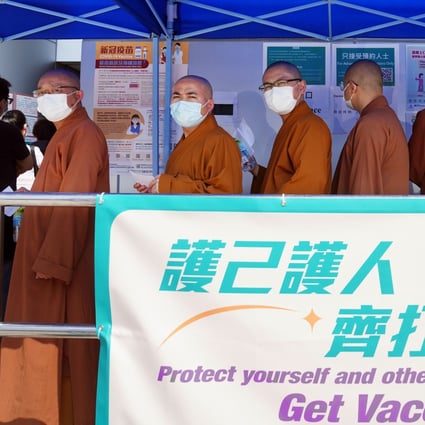 Monks queue for a Covid-19 shot in Tuen Mun on Monday. Photo: Sam Tsang