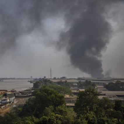 Black smoke billows from an industrial zone in Yangon on Sunday. Photo: AP