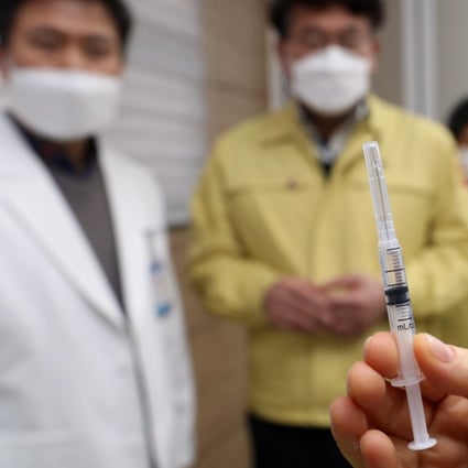 A medical worker in South Korea holds up a syringe containing AstraZeneca's Covid-19 vaccine. Photo: DPA