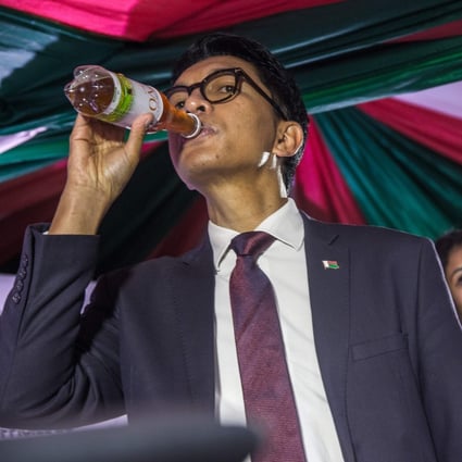 Madagascar's President Andry Rajoelina drinks a sample of ‘Covid Organics’ in April 2020. Photo: AFP
