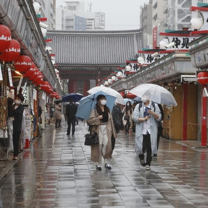 People walk in the rain in Tokyo’s Asakusa area on Sunday ahead of the scheduled lifting of the coronavirus state of emergency. Photo: Kyodo
