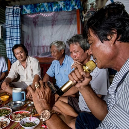 Shrimp farmers in the Mekong Delta enjoy a karaoke session during their group dinner. Photo: AFP
