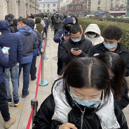 Hundreds of people line up outside a temporary vaccine centre at a building in Beijing. Photo: Simon Song