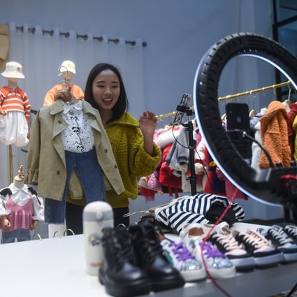 A woman sells children’s clothes on a live-stream in Huzhou, China, on February 8. Photo: Xinhua