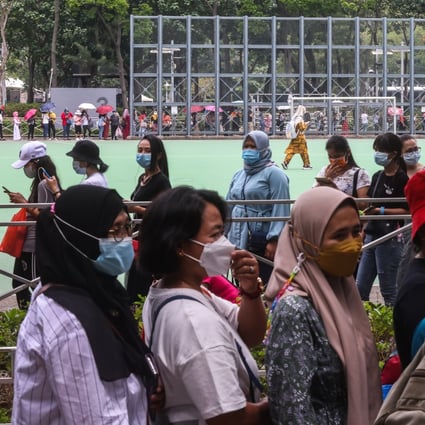Hong Kong foreign domestic workers stood in long queues over the weekend after a mandatory Covid-19 testing order was put in place for the community. Photo: K. Y. Cheng
