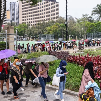 Domestic helpers queue up at Victoria Park for Covid-19 tests. Photo: K. Y. Cheng