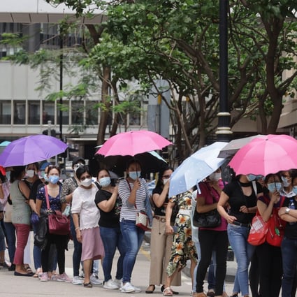 Helpers queue up to be tested for Covid-19 on Chater Road in Central on May 2. Photo: May Tse