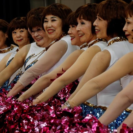 Members of senior cheer squad “Japan Pom Pom” pose for commemorative photos before filming a dance routine for an online performance in Tokyo, Japan, on April 12, 2021. Photo: Reuters