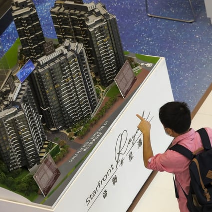A potential buyer looks at a model of Starfront Royale at a sales office in Tsim Sha Tsui on November 1, 2020. Photo: K.Y. Cheng