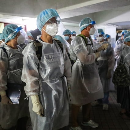 Medical workers in protective gear arrive at a Hong Kong housing block subject to a mandatory testing order. Photo: Edmond So