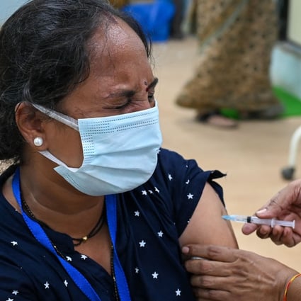 An Indian woman gets inoculated with a dose of the AstraZeneca vaccine. Photo: AFP