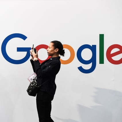 A woman takes a picture in front of the logo of Google as she visits the Vivatech start-ups and innovation fair in Paris, France, on May 16, 2019. Photo: AFP