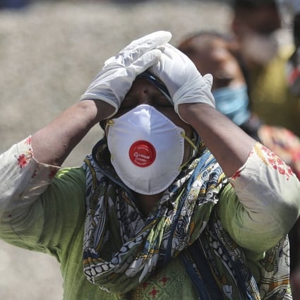 A relative of a Covid-19 victim mourns at a crematorium in Jammu, India, on April 25. India’s Serum Institute, in collaborating with AstraZeneca, has complete access to all the necessary vaccine IP, yet has been unable to meet local and international needs. Photo: AP