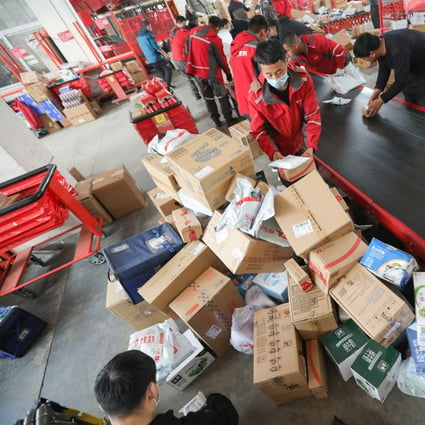 Workers are seen sorting out packages for delivery at JD Logistics’ Yizhuang smart delivery station in Beijing during last year’s November 11 Singles’ Day shopping gala. Photo: Simon Song