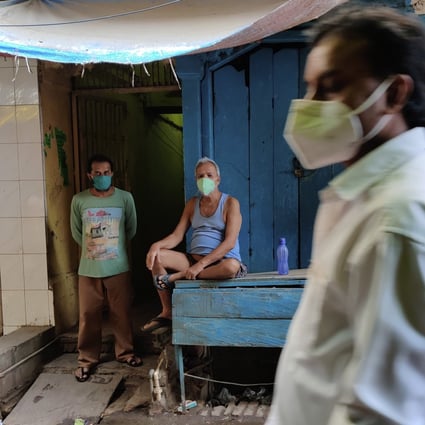 A shopkeeper wearing mask as a precaution against the coronavirus rests outside his closed shop in Prayagraj, India, on Sunday, May 9, 2021. Photo: AP Photo