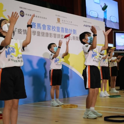 Pupils exercise with the help of online instruction at a promotional event for the release of the survey at Yaumati Catholic Primary School (Hoi Wang Road) on Tuesday. Photo: Edmond So