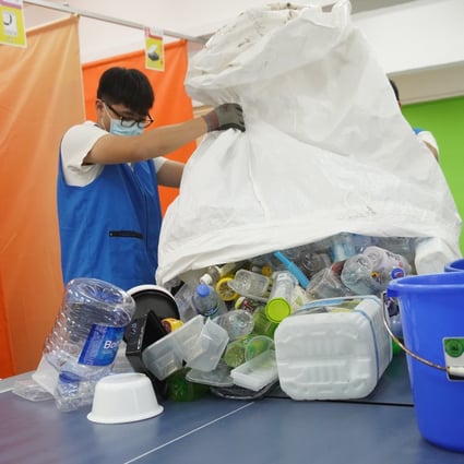 Member of Greeners Action collect waste plastic in Kowloon Bay. Photo: Winson Wong