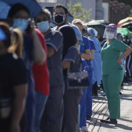 Healthcare workers wait to be inoculated in Honduras, where vaccines have been in short supply. Photo: AP